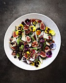 Fig salad with bacon, pansies, pine nuts and Parmesan