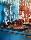 Full glass decanters in minibar in open cabinet