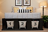 Scatter cushions on bed with storage baskets