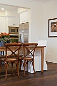 Dining area with kitchen in the background