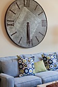 Cropped couch with large wall clock in living room; San Marcos; California; USA