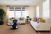 Lit floor lamps and seating in spacious living room; Azusa; California; USA