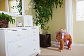 White cabinet with mirror and soft toy; Azusa; California; USA