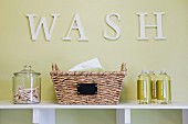 Jars and basket on shelf in laundry room; Azusa; California; USA