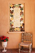 Chair, vase and tiled detail on wall; Santa Fe; New Mexico; USA