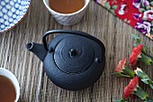 A black oriental teapot seen from above