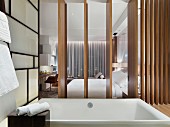 Bathtub in ensuite bathroom with wooden partition