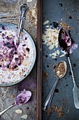 Yogurt dessert with fresh blackberry compote, cereals and flaked almonds