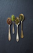 Various types of green tea on spoons