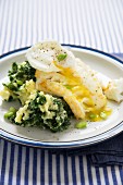Fried cod with a poached egg, mashed potatoes and green kale