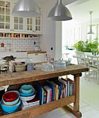 Old workbench converted into kitchen counter in Scandinavian kitchen with open doorway leading to dining room