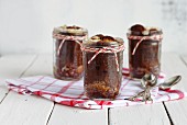 Mini German chocolate cakes with coconut and pecan nuts in jars as gifts