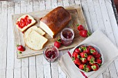 Sliced white bread with strawberry jam and fresh strawberries