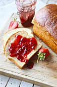 Strawberry jam on a slice of white bread