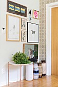 Gallery of pictures above house plant on side table and collection of traditional floor vases