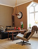 Rustic seating area in shades of brown with fur cushions and Advent arrangement on table