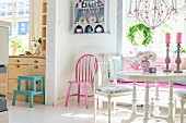 Vintage-style, white dining set, open doorway leading to kitchen, pink-painted chair in corner