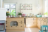 Bright, country-house-style kitchen with L-shaped counter and island counter