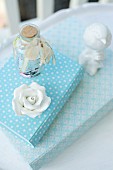 China rose and bird ornament on books with white and blue patterned covers