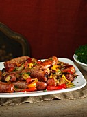 Sausages on a bed of vegetables