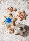 Various star biscuits on a sugared wooden board