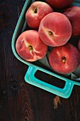 White peaches in a turquoise coloured baking dish