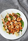 Seafood skewers (prawns and squid) on a bed of lettuce