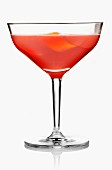 A red cocktail garnished with orange zest