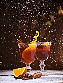 Red mulled wine with oranges, cinnamon, star anise and snowflakes