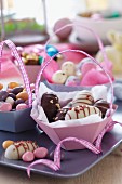 Easter sweets in paper baskets with handles