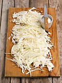 Shredded white cabbage on a chopping board