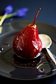 A poached pear in red wine