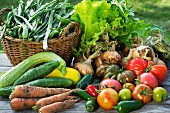 A harvest arrangement of garden vegetables on a wooden table