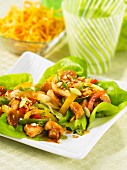 Lettuce wraps with chicken, peppers and onions