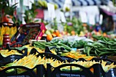Fresh courgette flowers on a vegetable stand