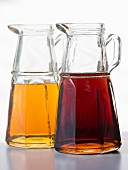 Two type of maple syrup in glass jugs