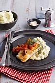 Fish fillet with tomato and olive sauce on dill mashed potatoes