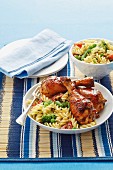 Honey-glazed chicken drumsticks and pasta salad