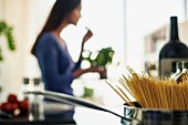 A unfocused image of a young woman cooking