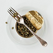 A tin of capers with a fork