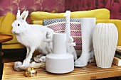 Various white vases and hare ornament on side table