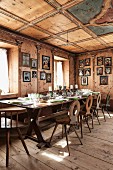 Festively set table in wood-panelled dining room of Italian chalet with antique, farmhouse furnishings