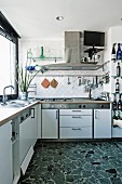 Modern, white, functional kitchen with terrazzo floor