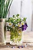 Edible wild flowers in drinking glass