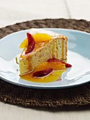 A slice of cake with blood oranges, orange and citrus fruit sauce