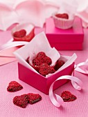 Dark chocolate hearts decorated with red sugar sprinkles as a gift