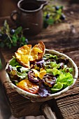 Mixed leaf salad with grilled vegetables in a rustic bowl