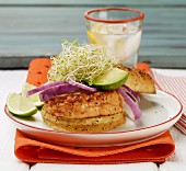 Salmon burger with avocado, bean sprouts and red onions