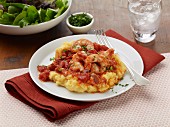 Polenta with shrimps, bacon and tomatoes