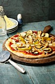 A vegetarian pizza with courgettes, aubergines and chilli peppers